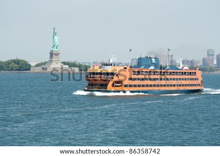 NEW YORK - AUG 03: Staten Island Ferry cruises past the Statue of Liberty on August 3, 2011 in New York.  The Ferry provides transportation to 20 million people a year and is free of charge.