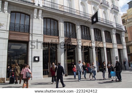 MADRID, SPAIN - OCTOBER 9, 2014: People entering and exiting the new Apple Store in Madrid. Located in the Puerta de Sol Plaza, the Madrid Apple Store opened on June 21, 2014.