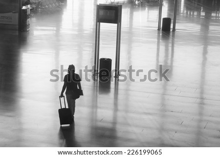 VALENCIA, SPAIN - OCTOBER 26, 2014: An airline passenger walking inside the Valencia Airport.  About 4.98 million passengers passed through the Valencia Airport in 2013.