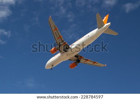 VALENCIA, SPAIN - NOVEMBER 7, 2014: An EasyJet aircraft landing at the Valencia, Spain Airport.  Easyjet is the second largest low-cost airline of Europe.
