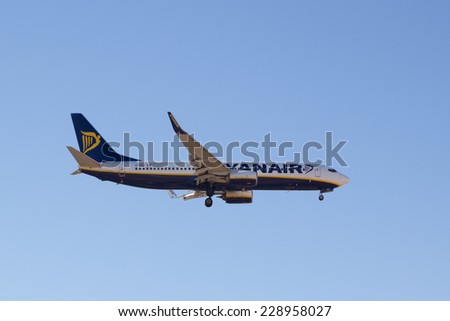 VALENCIA, SPAIN - NOVEMBER 6, 2014: A Ryanair aircraft landing at the Valencia, Spain Airport. Ryanair is the biggest low-cost airline company in the world.