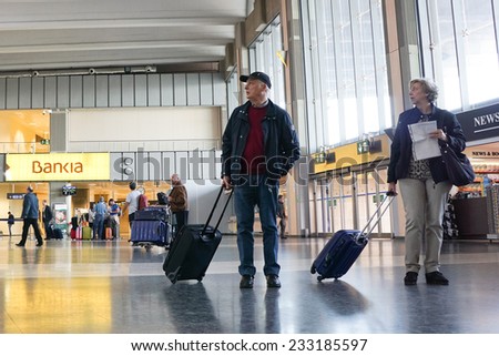 VALENCIA, SPAIN - NOVEMBER 25, 2014: Airline passengers inside the Valencia Airport.  About 4.98 million passengers passed through the airport in 2013.