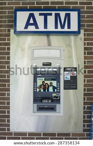 JACKSONVILLE, FL. USA - JUNE 13, 2015: An ATM machine in Jacksonville. The first modern ATM was an IBM 2984 and came into use at Lloyds Bank, Brentwood High Street, Essex, England in December 1972.