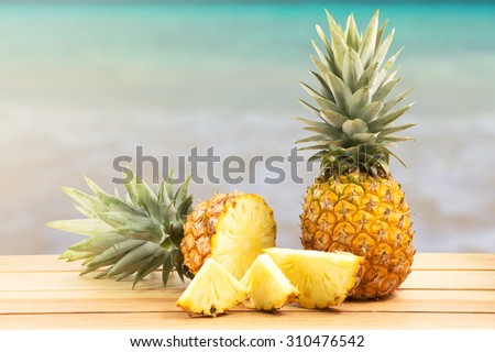pineapple on wooden table in a tropical landscape