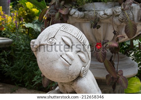 Cute girl sculpture in the garden.