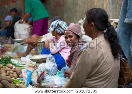 Lady selling raw foods in local market at Berau Indonesia on November 2014.