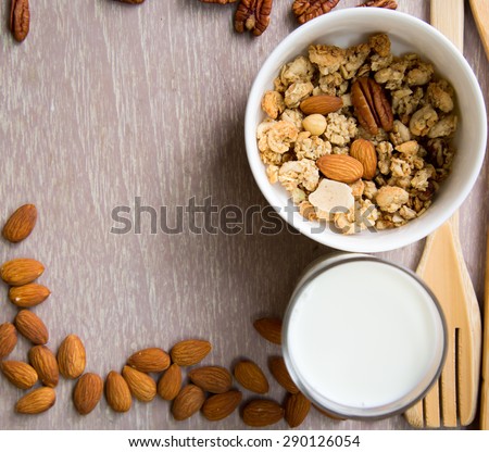 Healthy breakfast set with almonds raisins walnuts cereal and milk