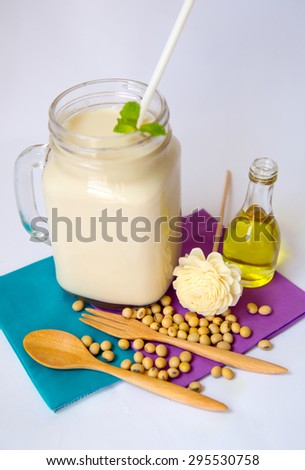 Soy products soy beans soy milk and oil in glass bottle