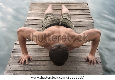 A man makes pushing up on the old wooden brige