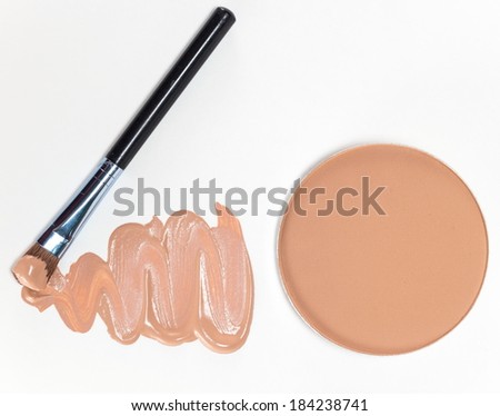 Cosmetics - pressed powder and liquid foundation makeup with a brush