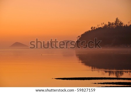 Orange Sunset Over Netarts Bay with Three Arch Rocks