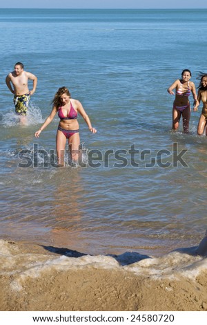 CHICAGO, IL - FEBRUARY 7: Swimmers exit the water at the Lakeview Polar Bear Club\'s 8th Annual polar plunge on February 7, 2009 at Oak Street Beach in Chicago, IL