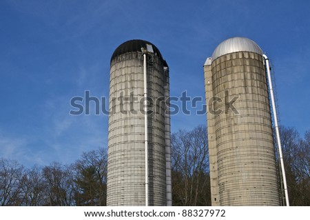 A Pair of Farm Silos Against a Blue Sky