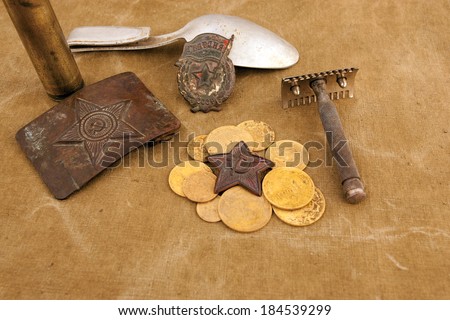 Soviet soldier buckle, spoon, shave and a couple of old soviet coins and red star, perspective on a tent