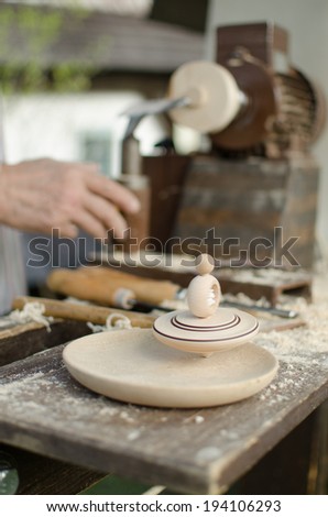 Simple Production spinning tops with hand and tool in Merry Hill near Hlinsko - Czech Republic