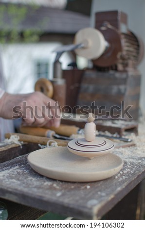 Simple Production spinning tops with hand and tool in Merry Hill near Hlinsko - Czech Republic