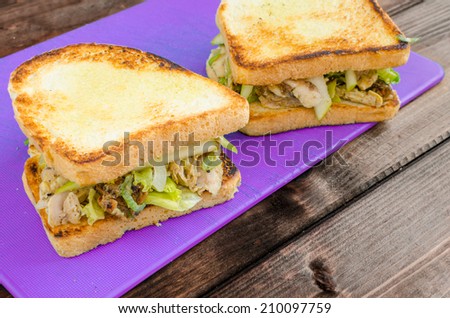 Chicken sandwich with celery, mustard, grilled chicken and salad