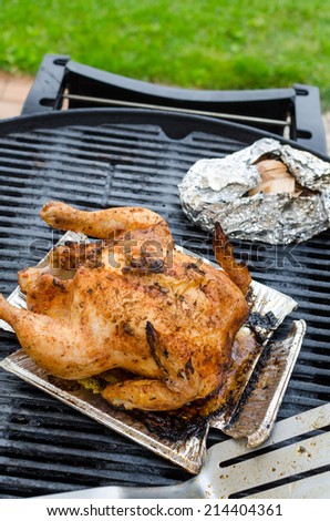 Grilled chicken whole, stuffed on grill, clean day