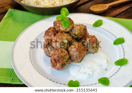 Beef meatballs with cilantro, garlic, couscous and mint dip