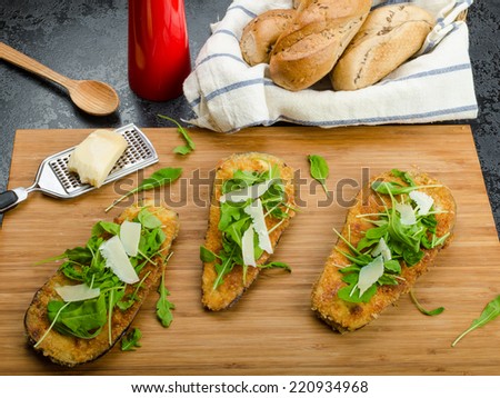 Fried eggplant, fried in parmesan crust, arugula salad with shavings of Parmesan cheese, fresh bread - czech dalamÃ?Â?Ã?Â¡nek