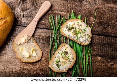 Homemade bread buttered with healthy seeds and herbs - chive