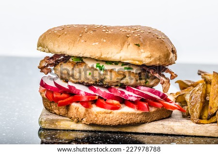 Chicken burger - minced chicken, bacon, paprika, radish and herb dressing, french fries. All home, healthy variant for burger