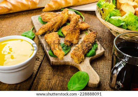 Corn crusted Chicken Tenders with spinach and toast, honey-dijon mustard dip, homemade bread baguette