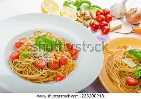 Lemon pasta with cherry tomatoes, basil and nuts, 2 plates, various serving