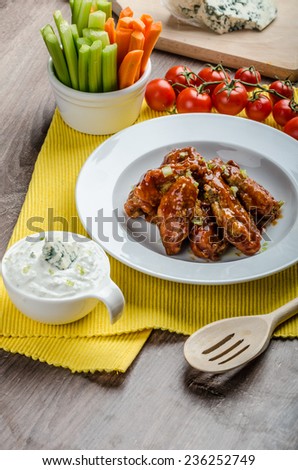 Chicken hot wings, homemade blue cheese sauce and fresh vegetables
