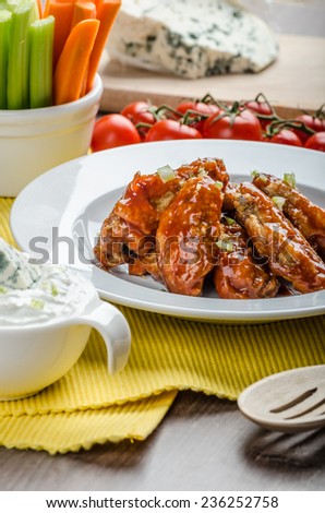 Chicken hot wings, homemade blue cheese sauce and fresh vegetables