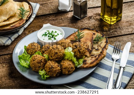 Health crunchy falafel with mint and garlic dip, naan bread with cumin and herbs