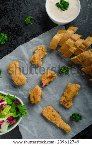 Salmon in herb batter with spicy dressing - fish and chips without fat chips with mixed salad with endive and czech beer