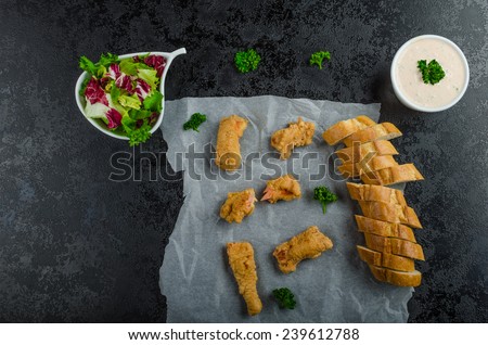 Salmon in herb batter with spicy dressing - fish and chips without fat chips with mixed salad with endive and czech beer