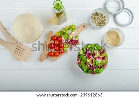 Preparation of mixed vegetable salad, lots of vegetable and seeds, bio healthy