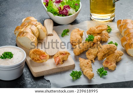 Salmon in herb batter with spicy dressing - fish and chips without fat chips with mixed salad with endive and czech beer