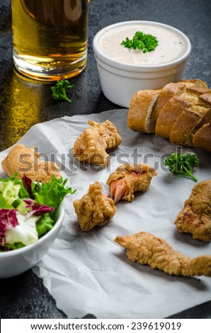 Salmon in herb batter with spicy dressing - fish and chips without fat chips with mixed salad with endive and czech beer