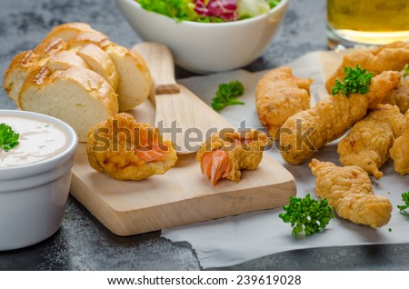 Salmon in herb batter with spicy dressing - fish and chips without fat chips with mixed salad with endive and czech beer