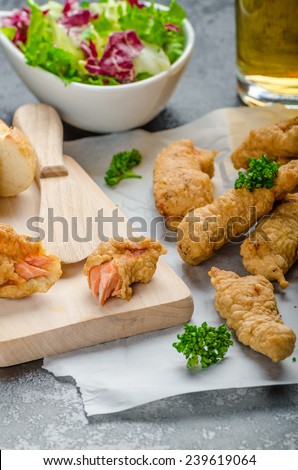 Salmon in herb batter with spicy dressing - fish and chips without fat chips with mixed salad with endive and czech beer