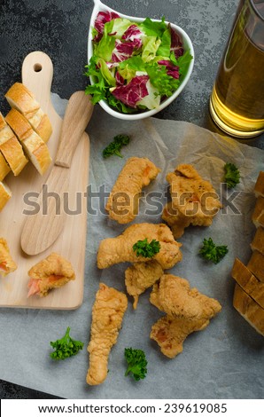 Salmon in herb batter with spicy dressing - fish and chips without fat chips with mixed salad with endive and czech beer