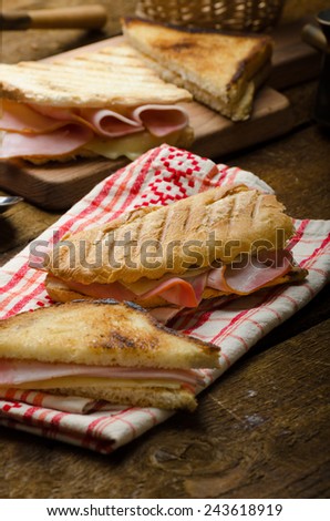 Quick dinner, toast with ham and cheese - panini, english toast, french with butter, dessert delicious churros