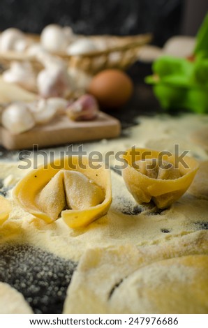 Making pasta from italian flour semolina, bio eggs, garlic, mushrooms tortellini at the end