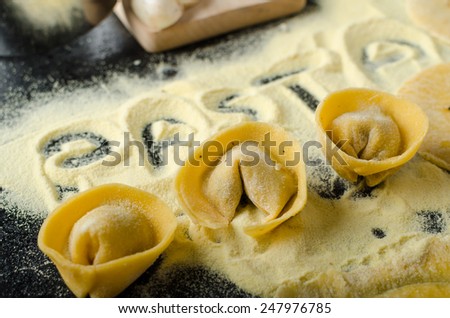 Making pasta from italian flour semolina, bio eggs, garlic, mushrooms tortellini at the end
