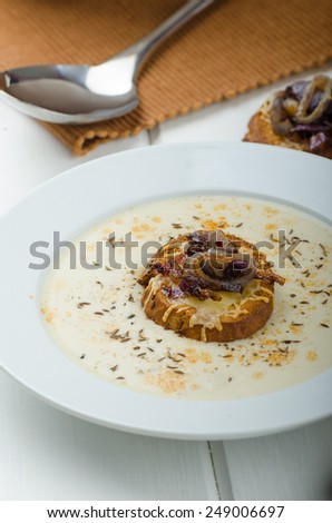 Creamy onion - garlic soup, toast with melted cheese and caramelized onions
