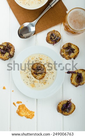 Creamy onion - garlic soup, toast with melted cheese and caramelized onions