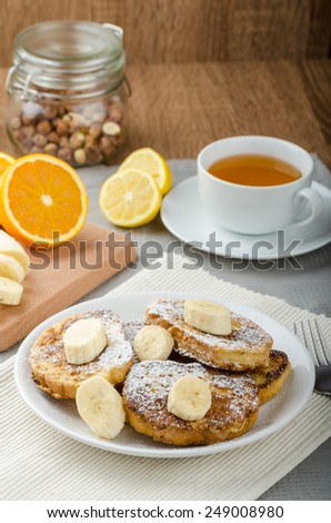 French toast to sweet, with banana sprinkled with sugar, fresh tea, breakfast
