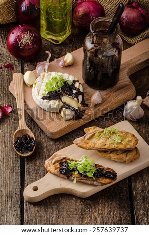 Toasted bread with brie cheese and caramelized onions, home made onion - red one with sugar and balsamic winegar. Micgreens on top