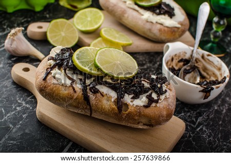 Dark bread spread with cream cheese and caramelized onions. Onion caramelized with sugar and balsamic vinegar - delicious