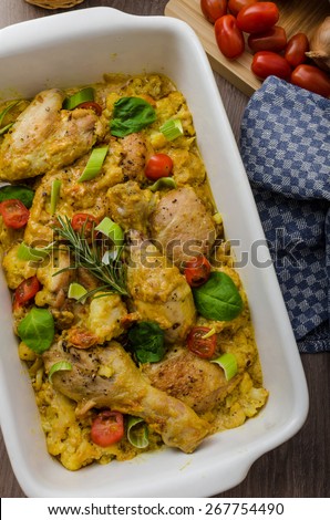 Roasted chicken quarters with curry vegetables, cauliflower, tomatoes and leek