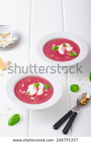 Soup from beet with light creame, nuts and basil sprinkled, organic beet