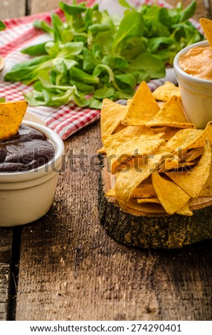 Tortilla chips with cheese dip and barbecue, czech beer